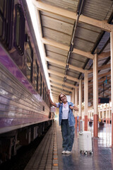 Fototapeta premium Older Asian Woman Traveling Solo Happy Adventure Train Station Platform Vacation Journey Transport Explorer Senior Traveler Retiree Passenger Trip