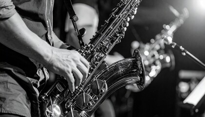 Obraz premium Close-up of a musician playing a saxophone during a performance, with another saxophone visible in the background.