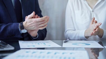 Business team clapping hands after successful presentation. Businesspeople group
