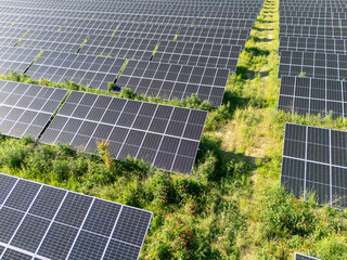 Aerial view of solar power station on a green field. Sustainable development