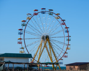 Ferris wheel on a blue sky background.