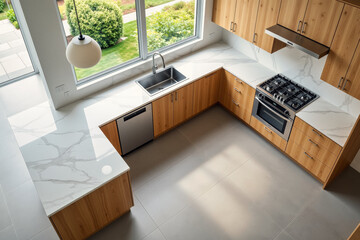 An aerial view showcases a modern kitchen featuring warm wood cabinetry, white marble countertops, stainless steel appliances, and large windows overlooking a lush green landscape.