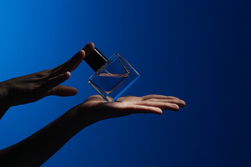 Elegant Glass Perfume Bottle Floating Above a Hand