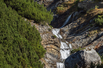 a small waterfall along the road road that goes up the the Stelvio Pass inside the Stelvio National Park on the Lombard side, Sondrio, Italy