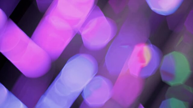 Abstract purple and pink bokeh lights moving in soft motion, dreamy visual loop ideal for festive atmosphere or creative background