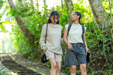 Asian Indonesian Women Hiking Through Lush Jungle Path in Yogyakarta