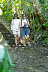 Asian Indonesian Women Hiking Through Lush Jungle Path in Yogyakarta