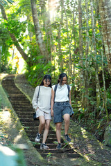 Asian Indonesian Women Hiking Through Lush Jungle Path in Yogyakarta