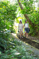 Asian Indonesian Women Hiking Through Lush Jungle Path in Yogyakarta