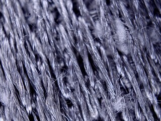 Extreme Macro Woven Fabric Texture with Intricate Fiber Details and Subtle Silver Tones.