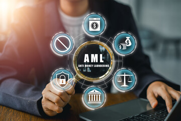 Businessman using laptop with anti money laundering icons, symbolizing financial security and compliance.