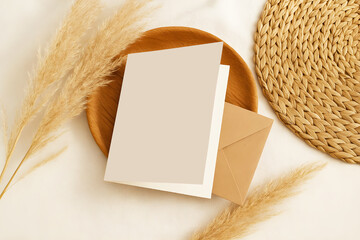Blank Card Mockup, greeting card mockup with Envelope on Wooden Plate and Pampas Grass