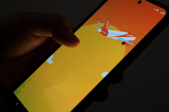 Person using Easyjet flight booking application on mobile phone