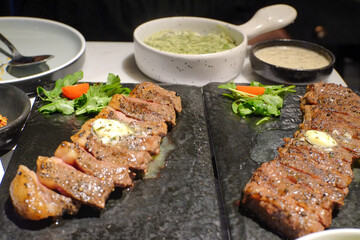 Delicious Grilled Steak Platter with Side Dishes: A mouthwatering food photography showcasing tender steaks seasoned and grilled served with fresh vegetables for gourmet food stock