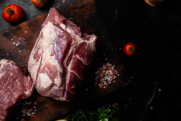 Raw pork neck on a wooden board on the table