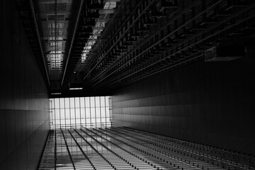 Symmetrical view of a modern building ceiling with linear architecture and dramatic perspective