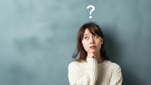 Young woman thinking with question mark overhead. Confusion and decision making concept.