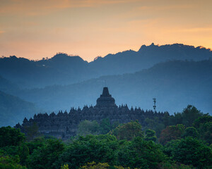 Borobudur Temple's silhouette at sunset is a breathtakingly beautiful sight, with the majestic structure's intricate carvings and stupas standing out against the vibrant colors of the sky © Matheus