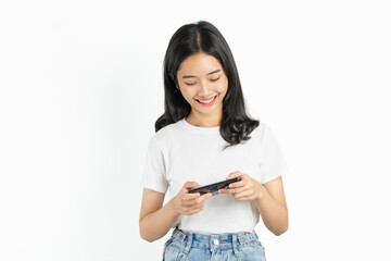 Happy young Asian woman playing an online game on a smartphone on white background.