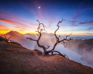 Ijen Crater at sunset is a breathtakingly beautiful sight, with the sulfur lake glowing a vibrant...
