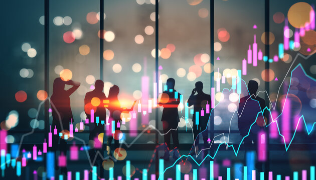 Businesspeople in office at night with holographic financial charts and graphs representing digital stock market data and economic analysis concept.