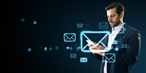 Businessman using smartphone with floating email icons on dark digital background representing modern virtual communication concept.
