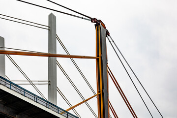 Fototapeta premium Crane lifting cables and electrical wires during bridge construction