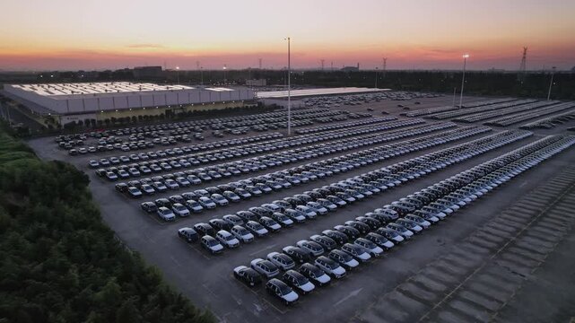 The newly produced cars from the automobile factory are parked in the parking lot