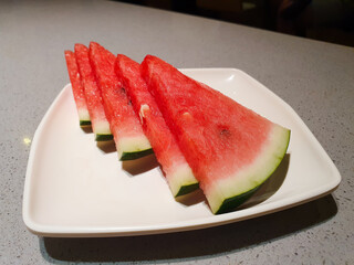 Slices of watermelon on white plate