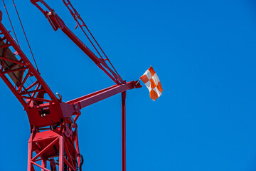 Red Tower Crane with FAA Aviation Safety Flag Near Airport