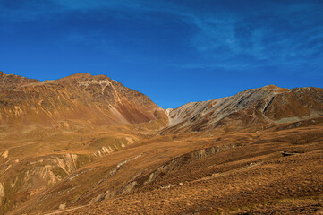 autumnal mountain landscape inside the Stelvio National Park along the Lombard side, Sondrio, Italy