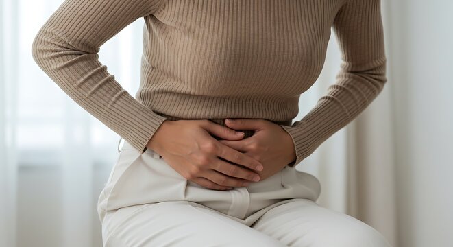 Woman holding stomach in pain suffering from period cramps
