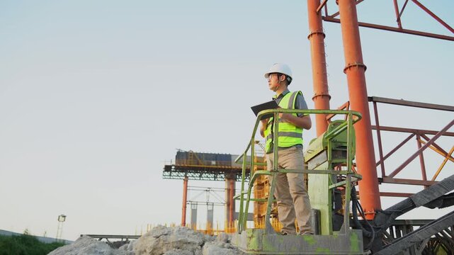 asian male engineer working in construction site for bridge