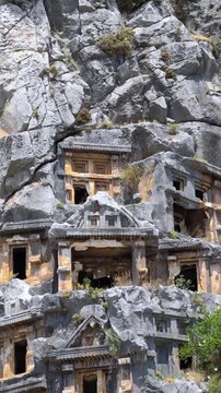 Rock-cut tombs of the ancient Lycian necropolis. Myra is an antique town in Lycia where the small town of Kale (Demre) Turkey. Close-up of rock cut tomb grave. 