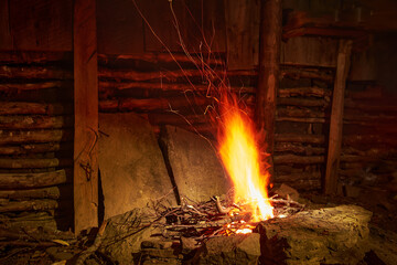 Open fire indoors. Primitive hearth in a smoky room.