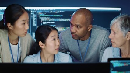 Four diverse people intently looking at a computer screen filled with code - Powered by Adobe