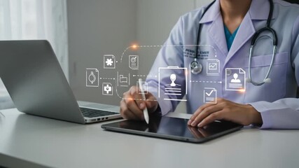 Doctor using tablet with digital medical records interface near laptop and stethoscope on the desk - Powered by Adobe