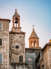 Fototapeta premium Gradska Ura clock tower in Split’s old town, Croatia, rises above ancient stone walls and narrow alleys, a timeless symbol of medieval heritage and coastal charm.