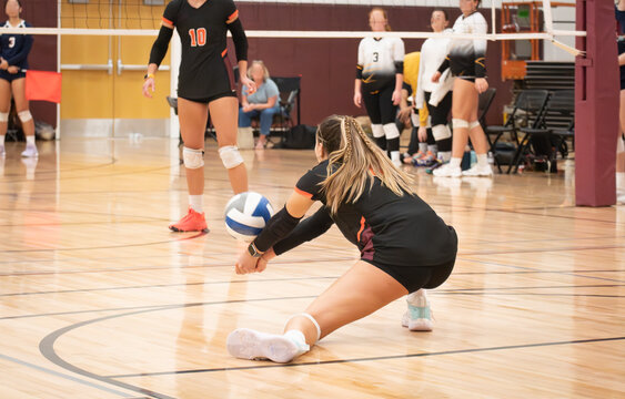 College volleyball player passing the ball with perfect form