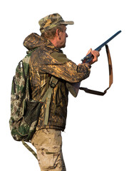 Obraz premium Hunting period, autumn season open. A hunter with a gun in his hands in hunting clothes in the autumn forest in search of a trophy. A man stands with weapons and hunting dogs tracking down the game.