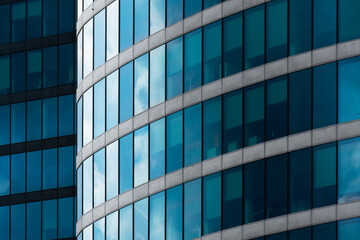 Curved office tower with continuous blue glass curtain wall