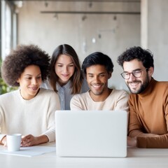Four diverse young adults gather around a laptop, smiling and collaborating in a bright, modern workspace.