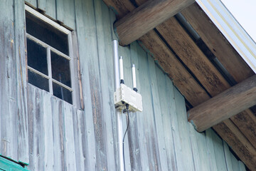 A mobile communication amplifier on the wall of the house.