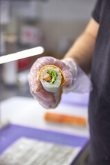 A vibrant assortment of fresh sushi, including nigiri, rolls, and sashimi, beautifully arranged on a dark slate. The vibrant colors and textures highlight the variety and freshness of the seafood.