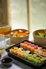 A vibrant assortment of fresh sushi, including nigiri, rolls, and sashimi, beautifully arranged on a dark slate. The vibrant colors and textures highlight the variety and freshness of the seafood.