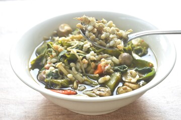 sweet Melientha suavis and mixed vegetable with red ant egg in fermenting fish sauce curry soup on bowl