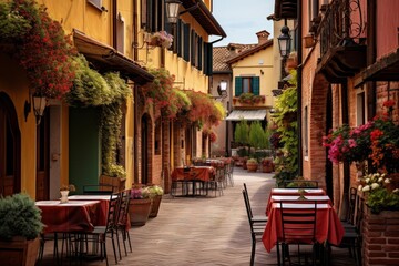Obraz premium Empty tables with red tablecloths await guests in a picturesque italian alley adorned with flowers