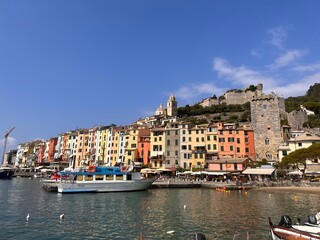The colorful waterfront of Portovenere, with its historic tower and hillside church rising above charming Ligurian homes