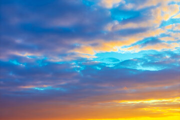 Layers of clouds, illuminated by the golden light of the setting sun. Sunset clouds a beautiful mix of vibrant colors
