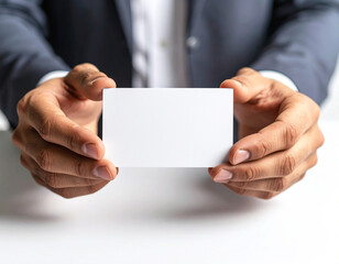 Close-up of hands holding a blank business card